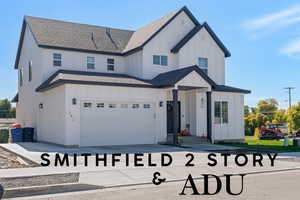 Modern farmhouse featuring roof with shingles, board and batten siding, driveway, and an attached garage