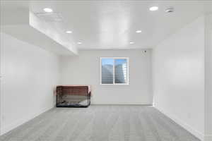 Unfurnished room featuring carpet floors and recessed lighting