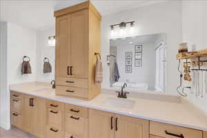 Bathroom featuring a bath, double vanity, and a shower stall
