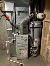 Utilities featuring strapped water heater and heating unit