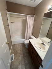 Full bath featuring a textured ceiling, shower / bath combination with curtain, and vanity
