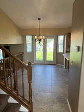 Interior space with a chandelier and stairway
