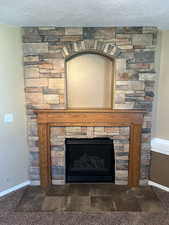 Detailed view of a textured ceiling and a fireplace