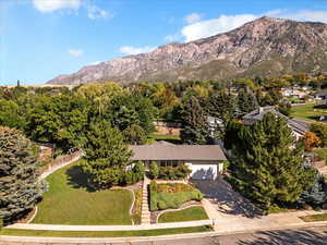 Aerial view of property and surrounding area with mountains