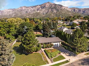 Aerial view of property and surrounding area with a mountainous background