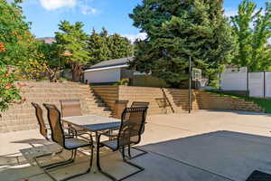 View of patio with stairs and outdoor dining area