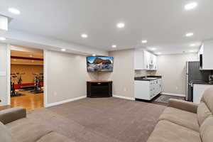 Living room with recessed lighting and dark colored carpet