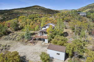 Aerial view of property and surrounding area with a mountainous background