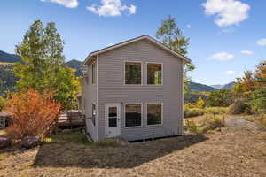 Back of house featuring a deck with mountain view