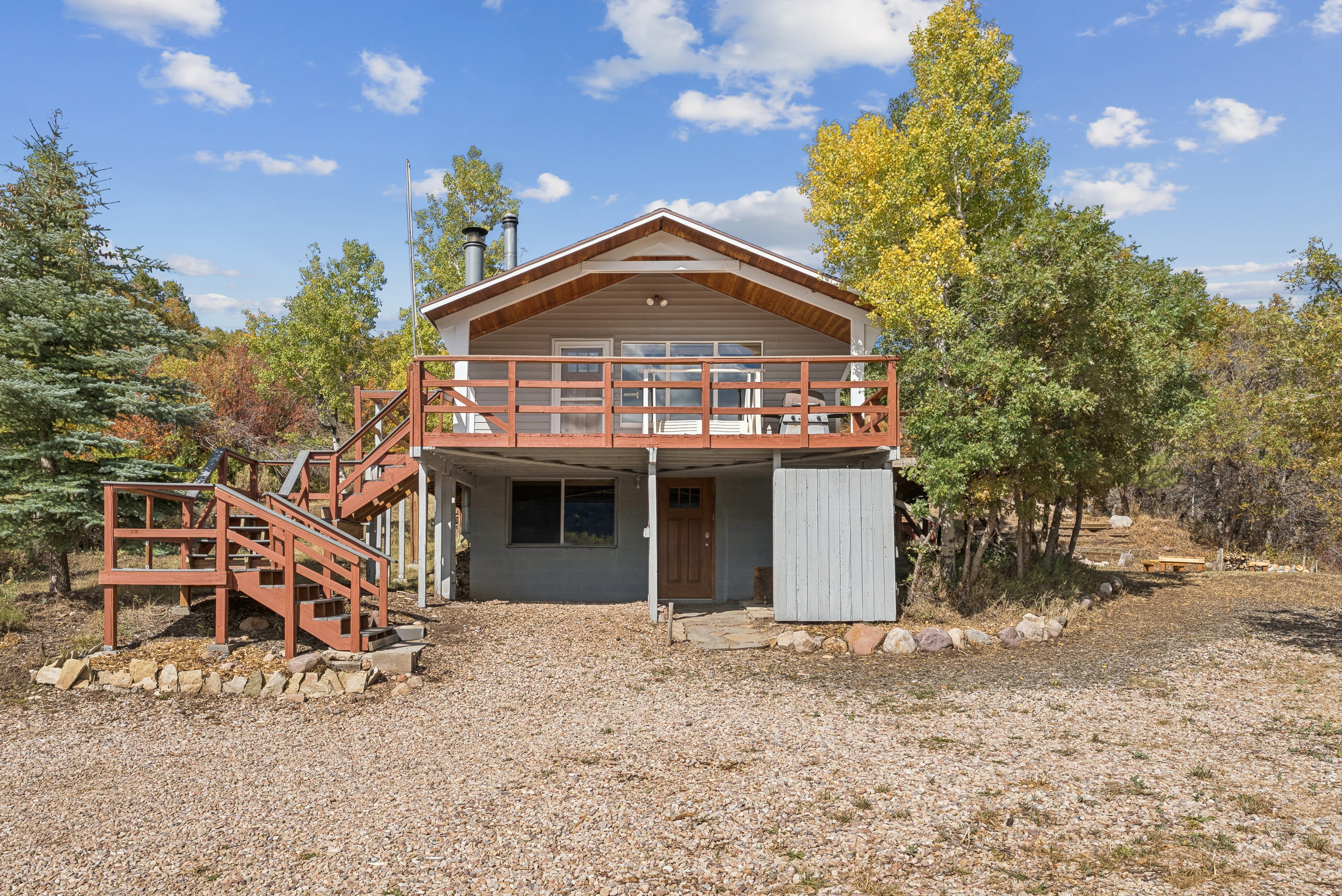 Rear view of property with a deck and stairway