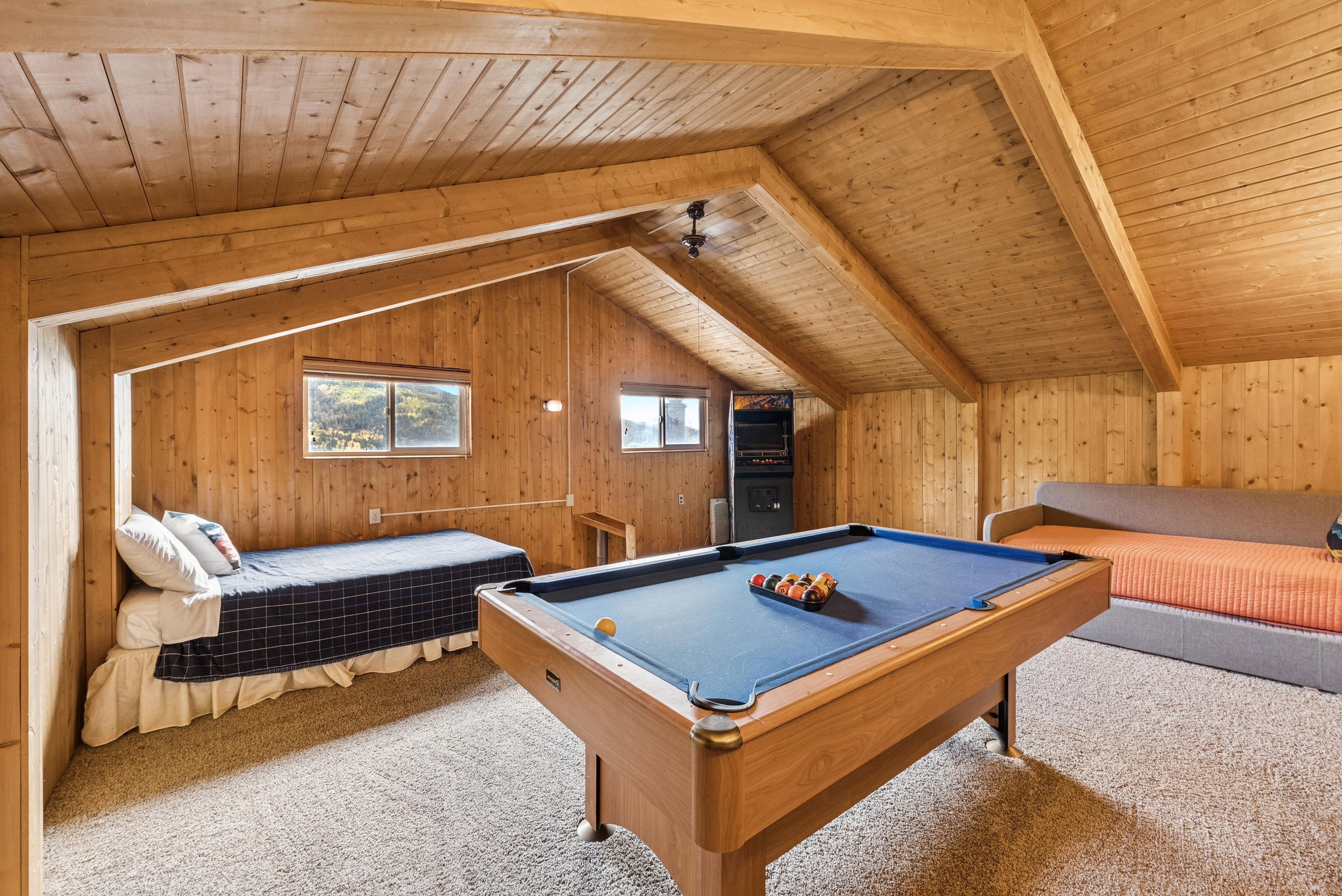 Playroom with carpet flooring, wooden walls, wood ceiling, and pool table