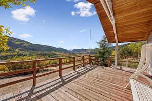 Wooden terrace featuring a mountain view