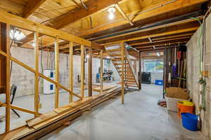 Below grade area featuring stairway and water heater
