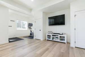 Workout room featuring light wood-type flooring and baseboards