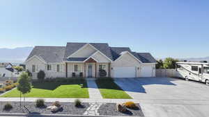 View of front of home with a mountain view, covered porch, driveway, and roof with shingles