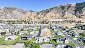 Aerial overview of property's location featuring nearby suburban area and mountains