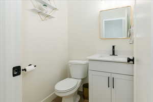 Half bath featuring vanity and toilet