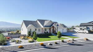View of front of house featuring concrete driveway, roof with shingles, and a mountain view