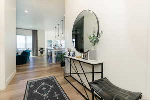 Hall with light wood-style flooring and recessed lighting