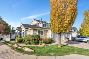 View of front of home with driveway and a garage