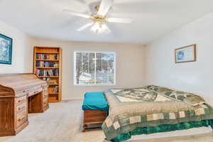 Bedroom with light carpet and ceiling fan