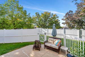 Fenced backyard with a gate and a patio
