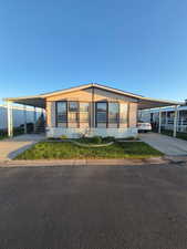 Manufactured / mobile home with a carport and concrete driveway