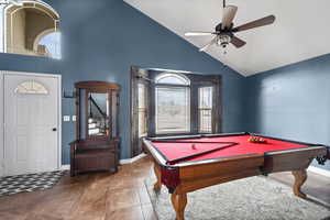 Rec room with high vaulted ceiling, pool table, ceiling fan, and tile patterned floors