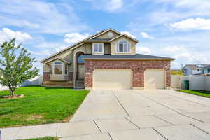 Traditional-style home with concrete driveway and stucco siding