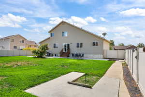 Rear view of property with a patio area, a fenced backyard, and a residential view