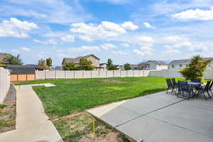 Fenced backyard featuring a residential view, a patio, and outdoor dining space