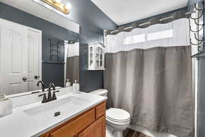 Bathroom with vanity and shower / bath combination with curtain