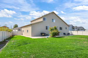 Back of property with a patio area, a fenced backyard, and a gate
