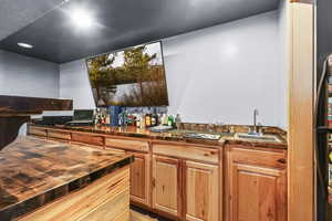 Kitchen with a textured ceiling and wooden counters