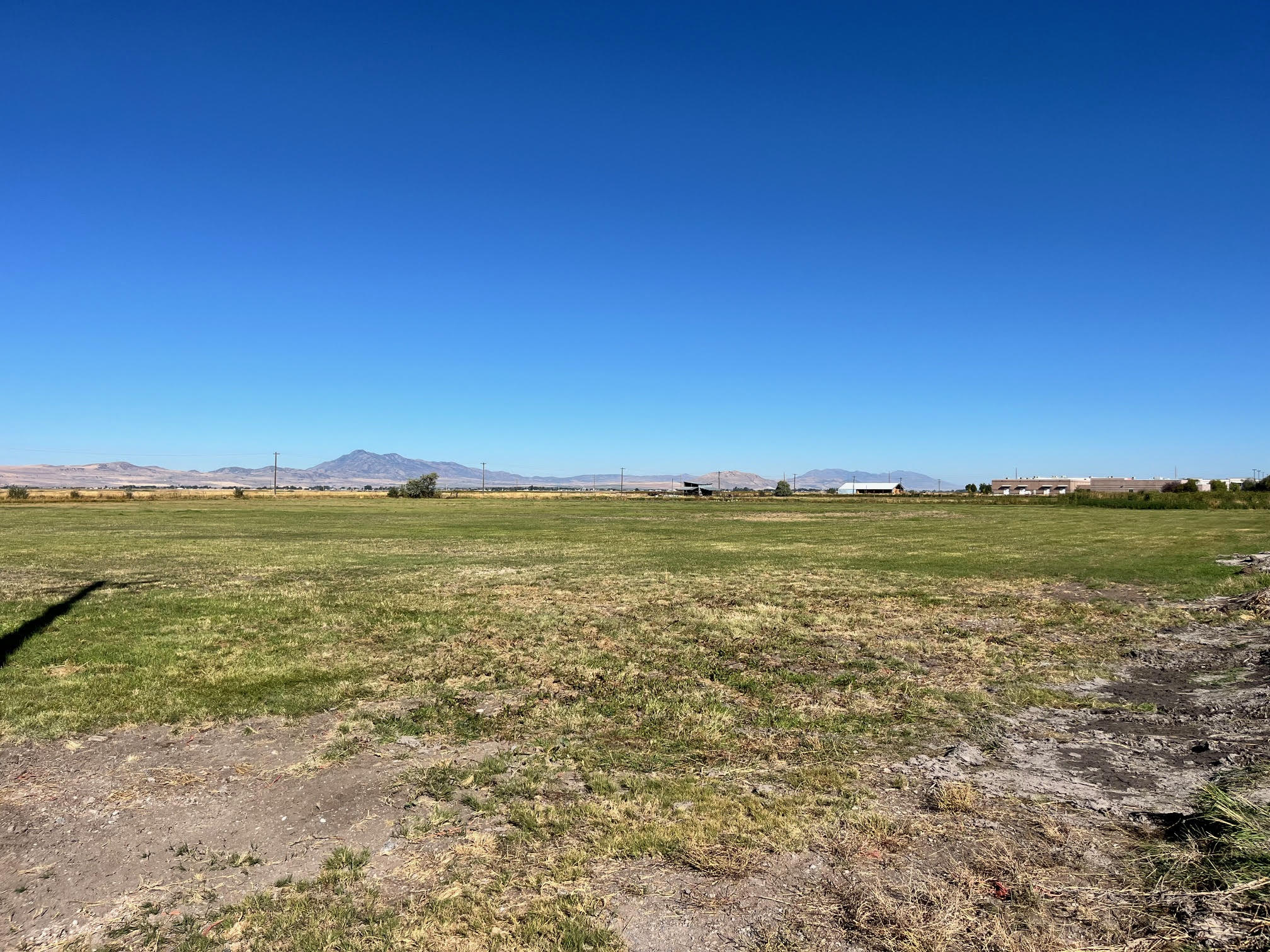 View of grassy yard with a view of countryside and a mountain view
