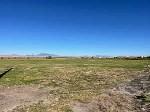 View of grassy yard with a view of countryside and a mountain view