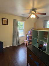Bedroom featuring dark wood-style flooring and ceiling fan