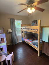 Bedroom with dark wood finished floors and ceiling fan
