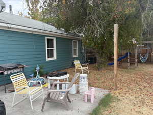 View of patio featuring a playground and area for grilling