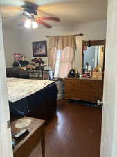 Bedroom featuring dark wood finished floors and a ceiling fan