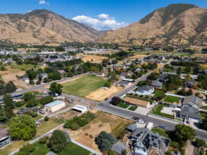 Aerial view of property's location with a mountain backdrop and nearby suburban area