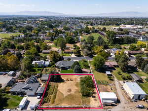 Aerial perspective of suburban area featuring property parcel outlined