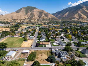 Aerial view of property's location with a mountainous background and nearby suburban area
