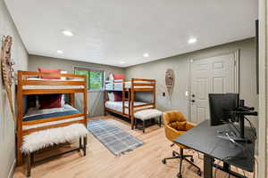 Bedroom featuring a desk, light wood-style flooring, and recessed lighting