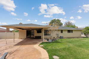 Rear view of property featuring brick siding, a chimney, a patio area, and a shingled roof