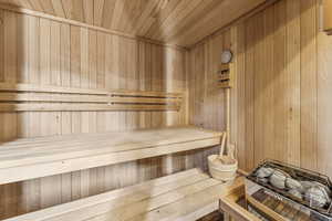Relaxing sauna / steam room with wood ceiling and wooden walls