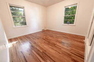 Spare room featuring light wood-style floors and baseboards