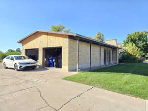 View of outdoor structure with driveway and a garage