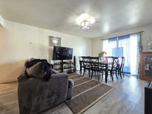 Living area featuring wood finished floors and a textured ceiling