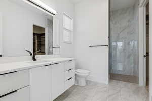 Bathroom with vanity, a stall shower, a walk in closet, and light marble finish flooring
